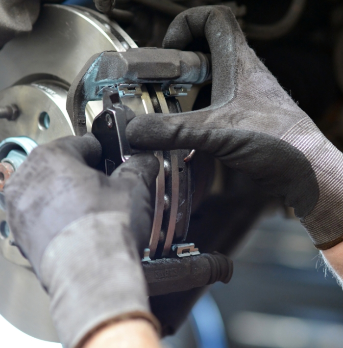 mechanic tuning up a car