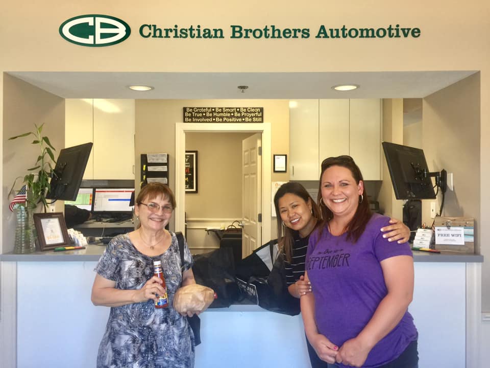 people smiling in christian brothers automotive store